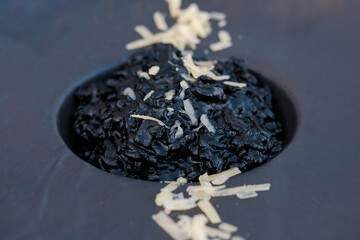 Delicious Italian seafood risotto with cuttlefish ink- squid ink. Black risotto. Healthy luxury...
