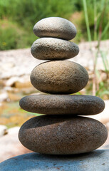 Fototapeta na wymiar Stone balancing with pebble tower on a river rocky beach