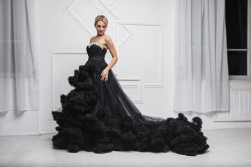 Young lovely woman wearing in a magnificent evening dress
