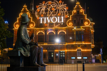 Hans Christian Andersen statue and Tivoli building facade, built in 1843. Entrance to Tivoli Garden, one of the oldest operating amusement parks in the world.  Copenhagen - Denmark - obrazy, fototapety, plakaty