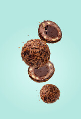 round chocolates flying on a blue background