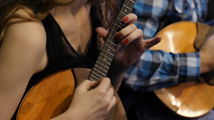 Woman Playing Music With Balalaika