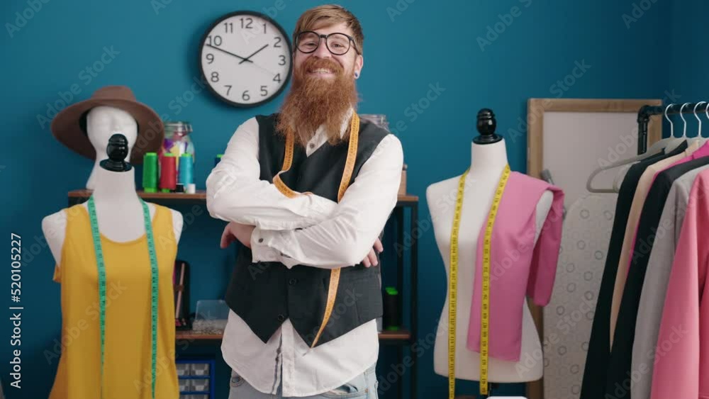 Poster young redhead man tailor smiling confident standing with arms crossed gesture at clothing factory