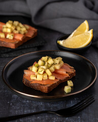 Food photography of sandwich with smoked salmon, toast, cucumber, lemon
