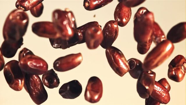 Dates soar up and fall down. On a gray background. Filmed is slow motion 1000 fps.