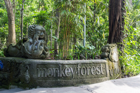 Monkey Forest stone sign with a sculpture on the theme Asian legend about monkeys. Ubud, Bali, Indonesia