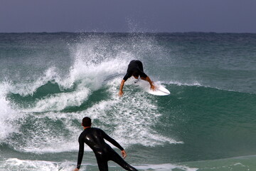 Surfing on high waves in the Mediterranean.