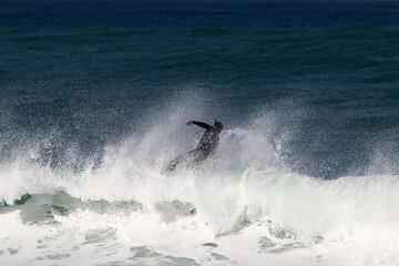 Surfing on high waves in the Mediterranean.