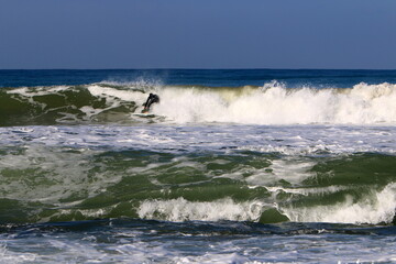 Fototapeta premium Surfing on high waves in the Mediterranean.