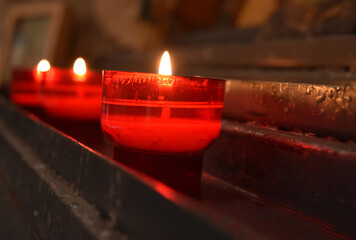 red candle burning in a church detail