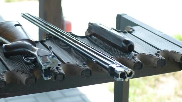 Double-barreled shotgun at the table.  sports field for a shooting test is shooting at flying skeet