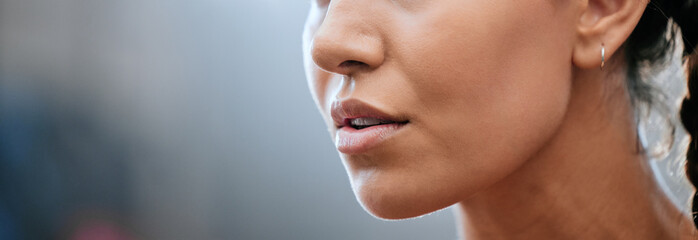 Closeup banner of a womans face, mouth and chin with blurred copy space. Young female looking...