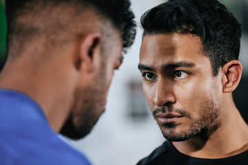 Serious, strong and fit male athletes staring, facing and looking tough. Closeup face of two men ready to challenge and battle against their teams before a fight, match or competition
