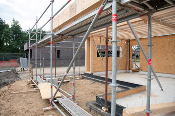 strong metal scaffolding at the construction site of a new house, the beginning