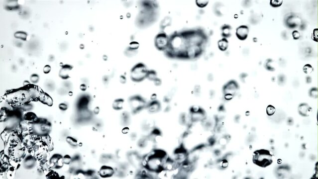 Splashes of water in motion. On a white background. Filmed on a high-speed camera at 1000 fps.