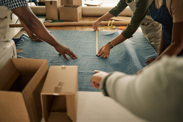 Design, manufacturing and making clothes with measuring tape in fashion and creative studio...