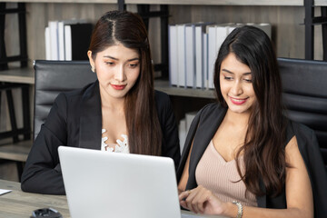 Young women in office working together on desktop