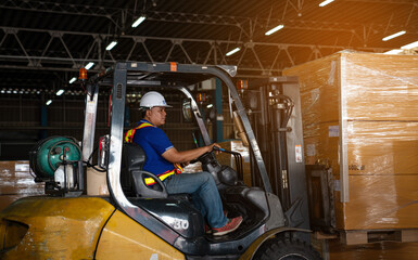 Warehouse worker driver in uniform delivery and loading pallet product by forklift.