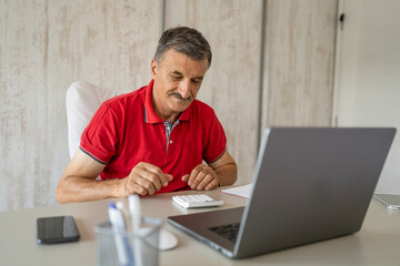 One senior man entrepreneur businessman work on laptop at office