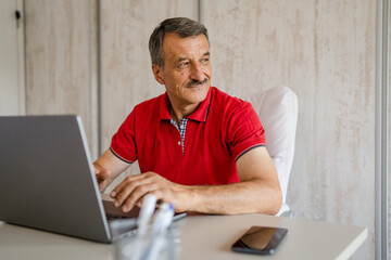 One senior man entrepreneur work on laptop computer at office