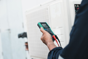 Air conditioner technicians use a multimeter to check electricity and Part of the preparation to install a new air conditioner.