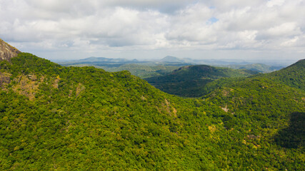 Fototapeta premium Mountain landscape with mountain peaks covered with forest. Slopes of mountains with evergreen vegetation. Sri Lanka.
