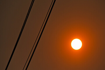A mashup of a Sunrise sillouetting power lines through wildfire smoke.