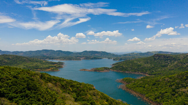 Aerial view of Mountains with rainforest and blue lake. Kalu Ganga Reservoir, Sri Lanka.