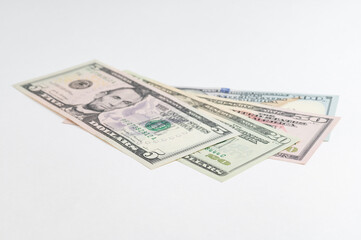 5, 20, 50, 100 dollars banknotes at different angles. Close up of dollars on white background.