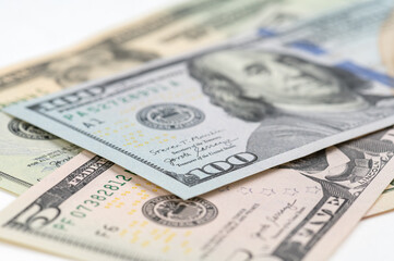 5, 20, 50, 100 dollars banknotes at different angles. Close up of dollars on white background.