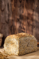 whole wheat baking bread with grains for healthy eating on wood table in kitchen