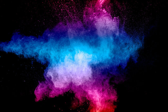 Pink Blue Dust Particles Splash On Black Background.Pink Blue Powder Splash.