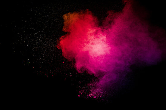 Pink Dust Particles Splash On Black Background.Pink Powder Splash.