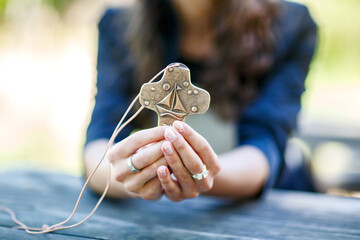 Hands of girl holding crucifix for holy confirmation or communion.