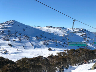 Taking the chairlift up the snowy mountains in Perirsher Valley, Australia