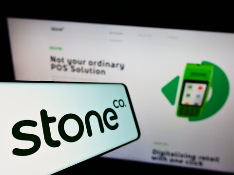 Stuttgart, Germany - 01-06-2022: Cellphone with logo of Brazilian fintech business Stone Company (StoneCo) on screen in front of website. Focus on center-left of phone display.