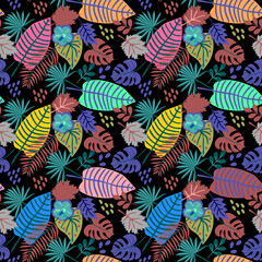Multicolored tropical leaves form a seamless pattern on a black background in vector. Exotic floral print for fabric.