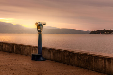 Sunrise over Lake Garda, binoculars waiting for tourists to take a look over the lake