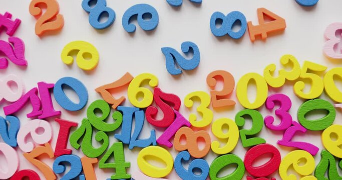 Colorful wooden numbers fill the background. Looped 4K stop motion animation