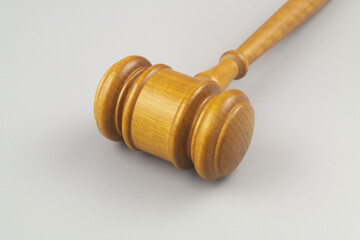 Wooden judge gavel on gray background close up. Laws, justice, court and legal system concept.