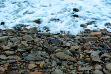 Nature background with sea waves hitting the sea shore. Scenic view of sea against cloudy sky