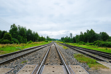 Fototapeta na wymiar Rails, track, railway on dark day, close-ups. Railway junctions. Defocused