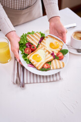 Heart shaped Fried Egg on Toast Bread and cup of fresh hot espresso coffee