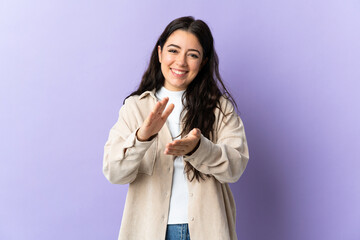 Young caucasian woman isolated on purple background applauding after presentation in a conference
