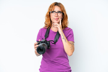 Fototapeta premium Young photographer caucasian woman isolated on white background having doubts and thinking