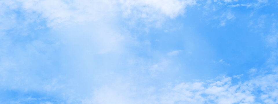 Clear and cloudy puffy and blurry blue sky background, bright and fresh blue sky and white clouds of summer or winter seasons.