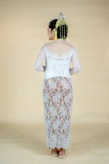 Beautiful model, wearing a Javanese Indonesian wedding dress and her property.