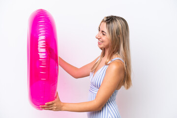 Young caucasian woman holding air mattress donut isolated on white background with happy expression