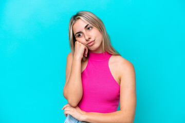 Fototapeta premium Young caucasian woman isolated on blue background with tired and bored expression