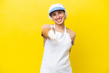 Fishwife woman over isolated background shaking hands for closing a good deal